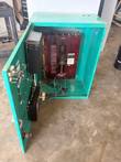 Onan transfer switch enclosure with door open, showing the switch mechanism, exercise clock and control boxes