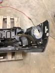 Back of the bumper's right end with brackets and a bag of hardware