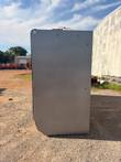 Side of the glass door merchandiser cooler, gray steel end panel with refrigerant lines on top
