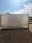 Rear of the glass door merchandiser cooler, silver insulated back panel with compressor on top