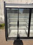 Left end of the glass door cooler with black end trim, gray canopy and wires on top