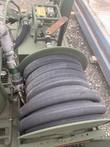 Hose reel with coiled black hose on the fuel transfer skid