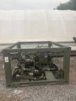 Olive-green military fuel transfer pump skid in a steel frame, seen from the front