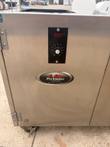Front corner of the stainless smoker with controls and logo, cropped at the wheels