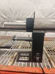 Label dispenser side view with roller shafts, base plate and power cord