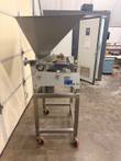 Hinds-Bock depositor from the side: stainless hopper, air cylinder and data plate on a casters stand