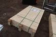 Strapped plywood shipping crate with handling labels, other crates alongside, on dirt