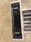 Top-down view into the fryer's rear flue chute, with the burner tubes visible at the right
