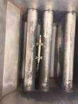 Three stainless heat-exchanger tubes in the fry tank with a temperature probe clamped between them