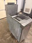 Vulcan stainless floor fryer from a front corner, open fry tank with MAX/MIN marks and rear flue