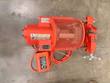 Orange Aeroquip pipe grooving machine from above with mesh motor guard, clamp vise, hand wheel and foot switch