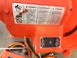 Multilingual warning label and black socket-direction plate marked OFF on the orange gear housing