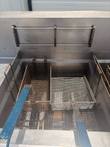 Giles fryer vat holding two wire baskets, with basket rack on the back wall