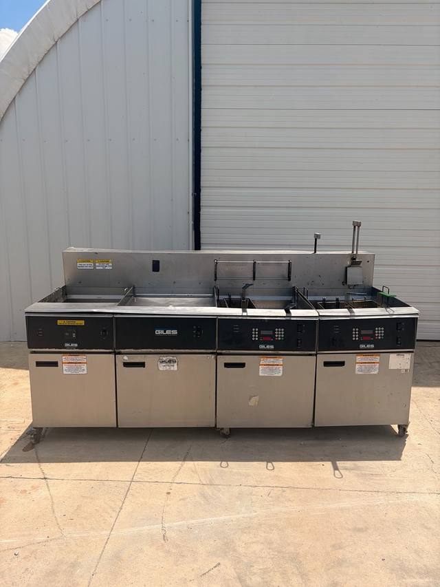 Giles fryer battery: water vat, dump station and two fryers on casters, front view