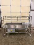 Eagle Group stainless steel cold food server on casters with two-tier shelf, utensil holder and compressor box under the pan