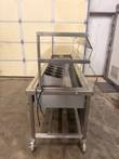 Stainless buffet table on casters with glass sneeze guard, utensil cylinders and power cord