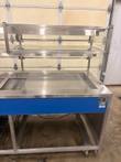 Right end of the Atlas Metal counter with stainless plate, front data plate and open rear frame on casters