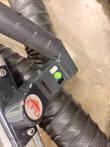 Handheld control on an EFD MINAC transformer with a green button and EFD logo knob