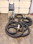 EFD MINAC induction heating system on a shop floor with its cables coiled beside the cabinet