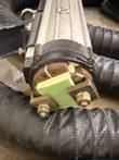 Transformer head end with brass clamps, green insulator plate and lifting eye on the EFD MINAC system