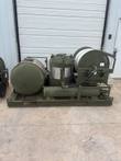 ARFF skid with AFFF tank, PKP tank, nitrogen cylinder and hose reel on an olive green steel frame.