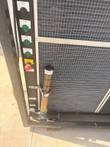 Chiller control column: system off button, power, pump and compressor lights, emergency stop and a fluid sight tube.