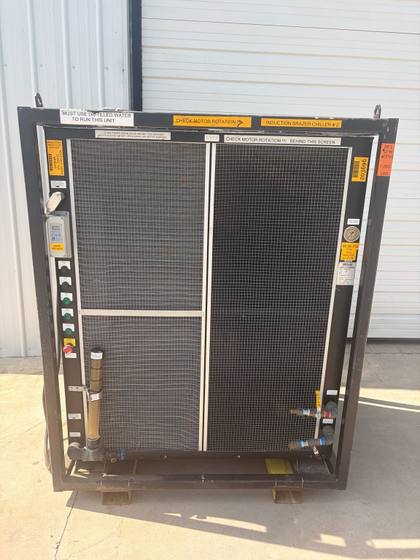 Front of the whole chiller in its steel frame: two mesh coil guards, controls left, gauge and valves right.