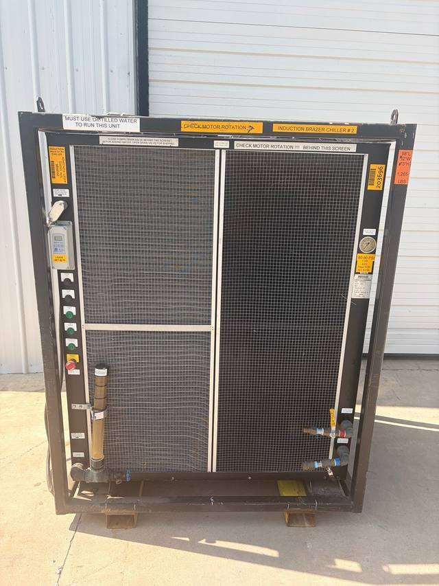 Front of the whole chiller in its steel frame: two mesh coil guards, controls left, gauge and valves right.