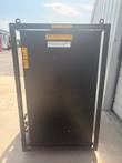 Back panel of the black chiller in its steel lifting frame, with Air Flow Up and distilled-water labels.