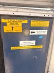 Blue tank panel with a sight glass, fill-to-halfway label and drain-before-shipping notices.