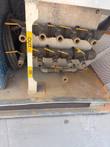 Brass quick-connect ball valve manifolds labeled OUT and IN at the bottom of the chiller.