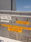 Aluminum container side marked 960 KGS with orange check motor rotation and ventilation warning stickers.