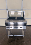 Stainless two-well steam table with raised sneeze guard, two temperature dials and lower shelf