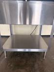 Stainless steel front panel and open undershelf of the steam table, on two tapered legs.