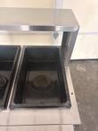 Black steam table well with a cast Always Use With Water plate and a Caution Hot label beside it.