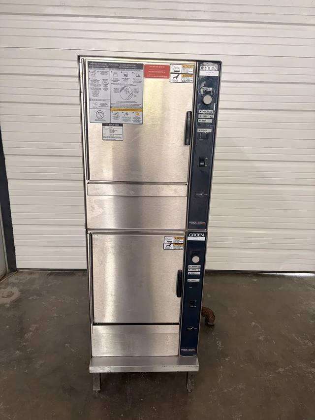 Groen double-stack boilerless steamer, front view, two stainless doors with blue control panels