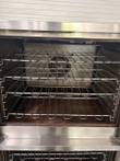 Convection oven cavity with chrome wire racks and the rear fan opening