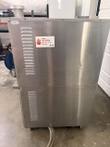 Side panel of a stacked convection oven with louvered vents and a Keep Hot Foods at 135 degrees F sticker