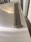 Perforated stainless vent tray on top of a stacked convection oven