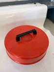Red insulated dewar lid with black carry handle, removed from the tank