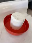 White foam neck plug sitting inside the upturned red dewar lid