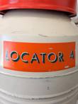 Orange Locator 4 label on a cream cryogenic dewar below the red lid, with chipped paint