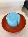Blue foam neck plug sitting inside the upturned orange dewar lid