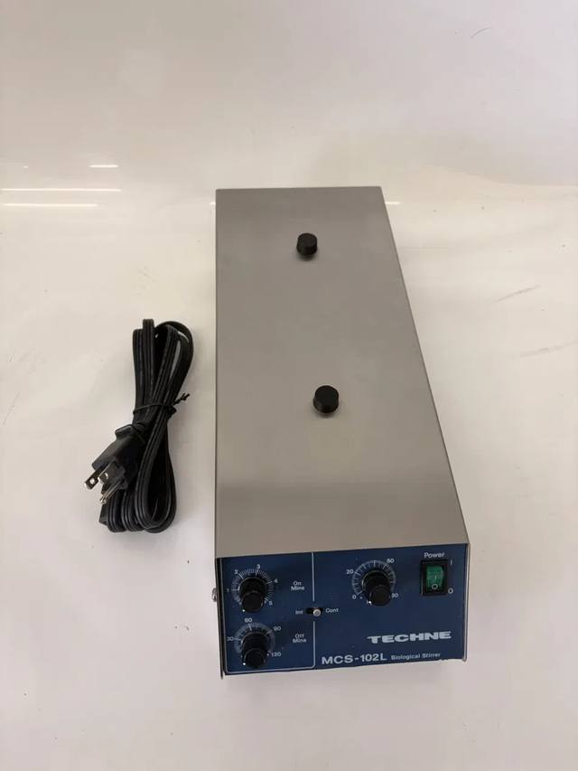 Techne MCS-102L Biological Stirrer, stainless steel top with two black knobs and blue control panel, power cord beside
