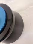 Cropped side of black rotor collar and blue lid on a white surface, rotor body behind