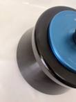 Black rotor collar and blue lid edge, cropped close-up of the tapered rotor body