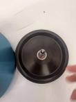 Underside of the black Sorvall rotor lid with center shaft, blue rotor body beside it