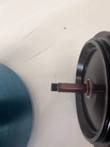 Threaded stem on the underside of the black Sorvall lid, blue rotor body at left