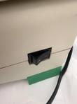 Black rocker power switch on the side of the cream iCycler housing, green foot below