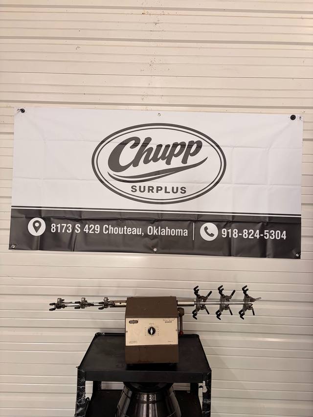 Burrell Wrist Action Shaker on a cart in front of a Chupp Surplus banner